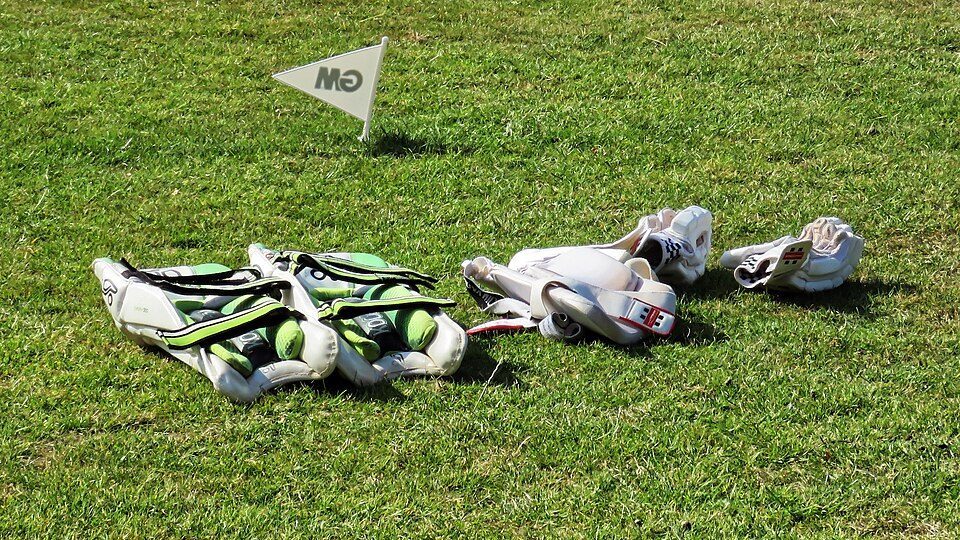 Cricket pads and gloves laid out for play