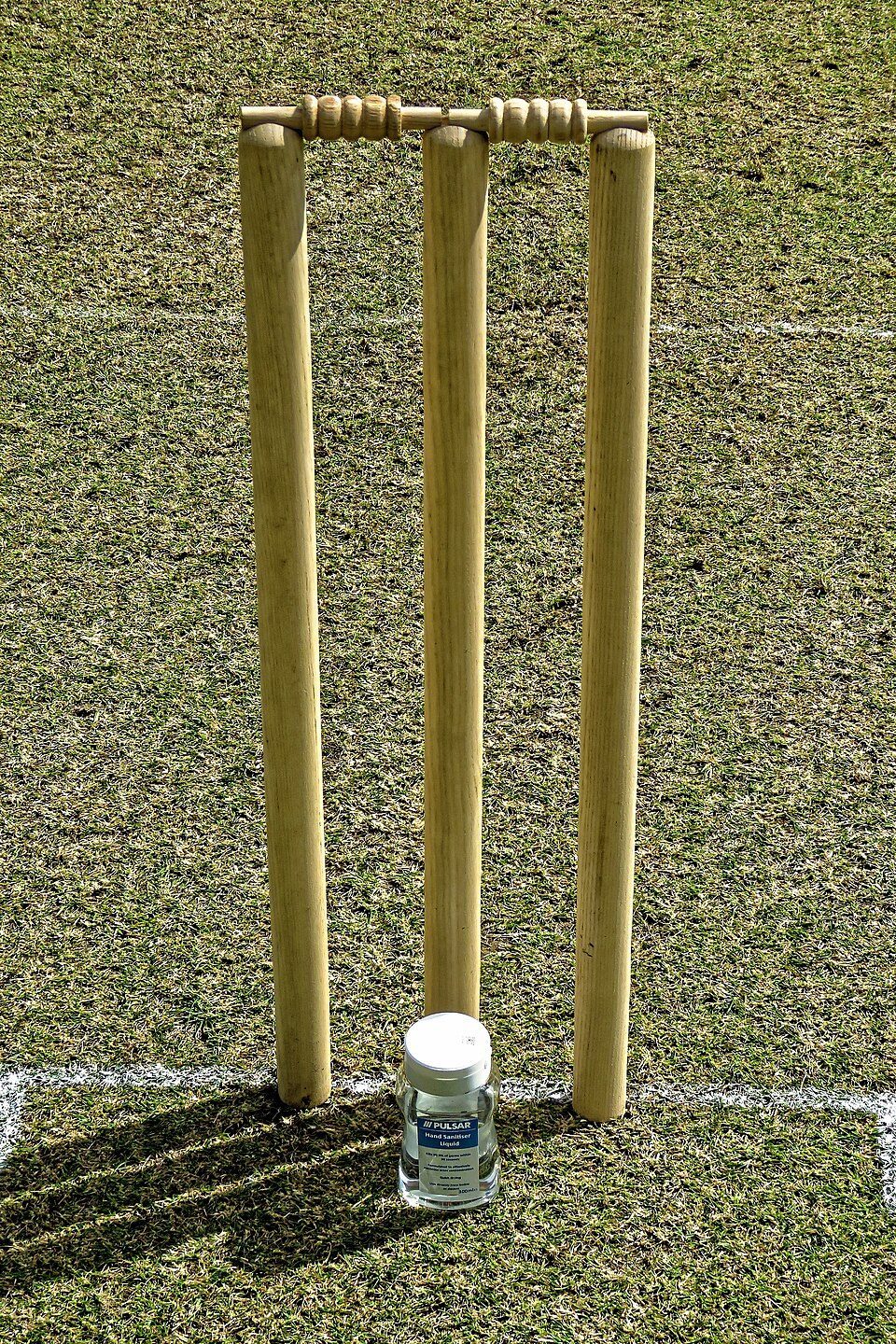 Cricket stumps on a grass pitch